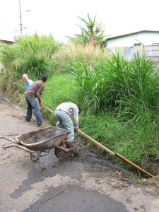 Cleaning out the gutters at the Abraham Project- don't drink this water!